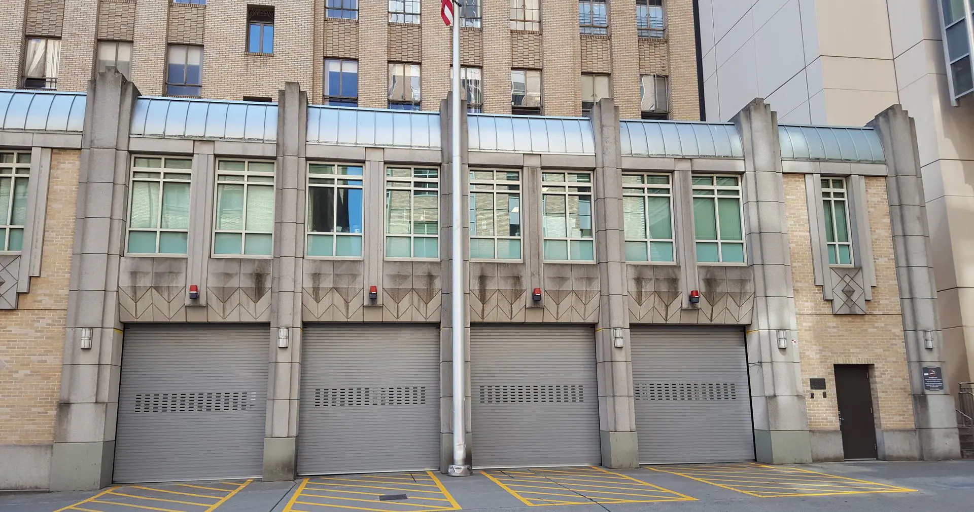 Four rolling steel doors on a commercial building