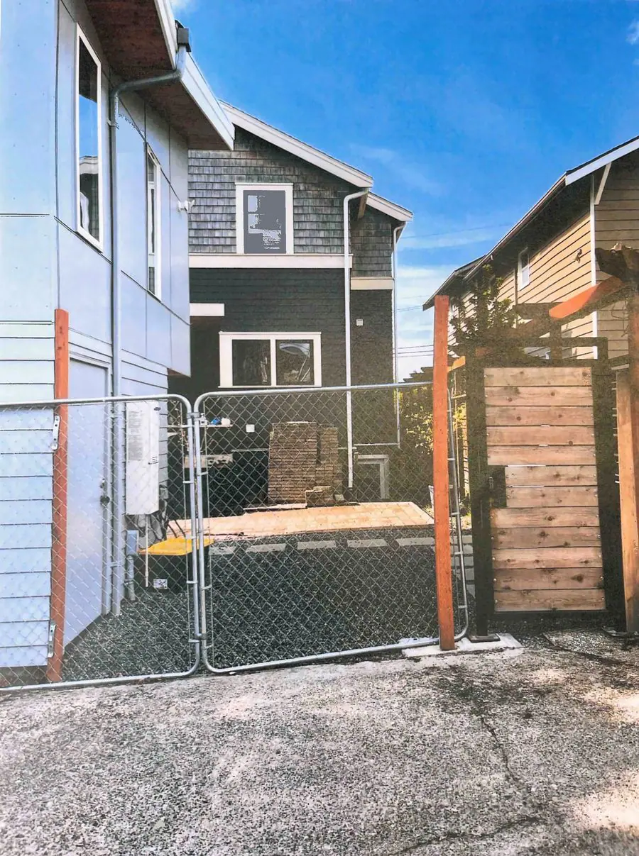 Chain-link gate across an alley between two buildings