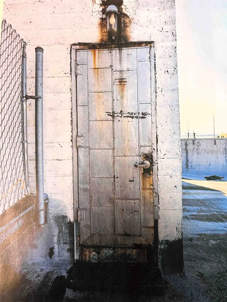Rusted steel door and frame on a rooftop