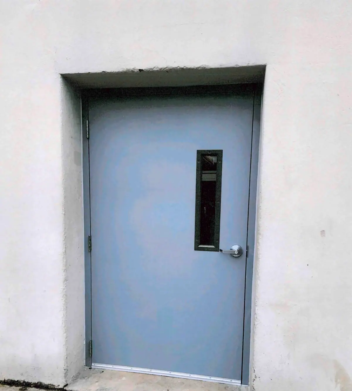 Blue-gray steel door with a narrow window