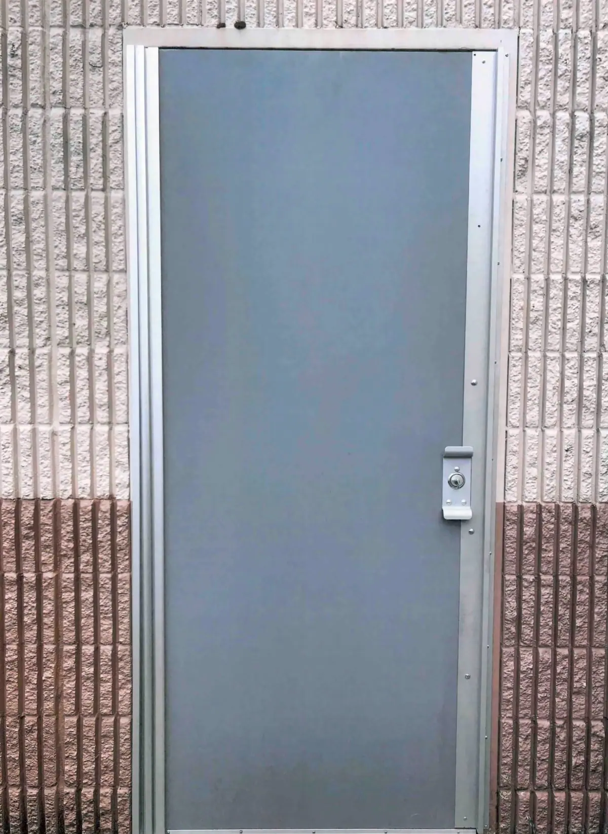 Gray steel door and frame in a block wall