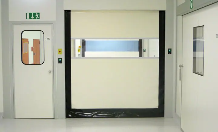 Interior high-speed fabric door with a vision panel in a clean white corridor