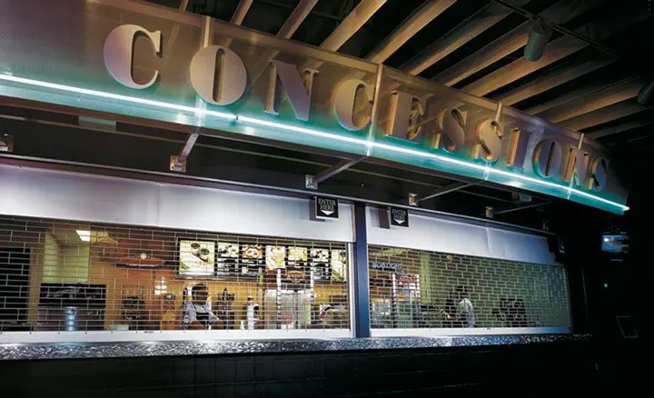Rolling grilles closed across a concession stand counter