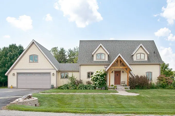 Cream-colored home with a gray two-car garage door
