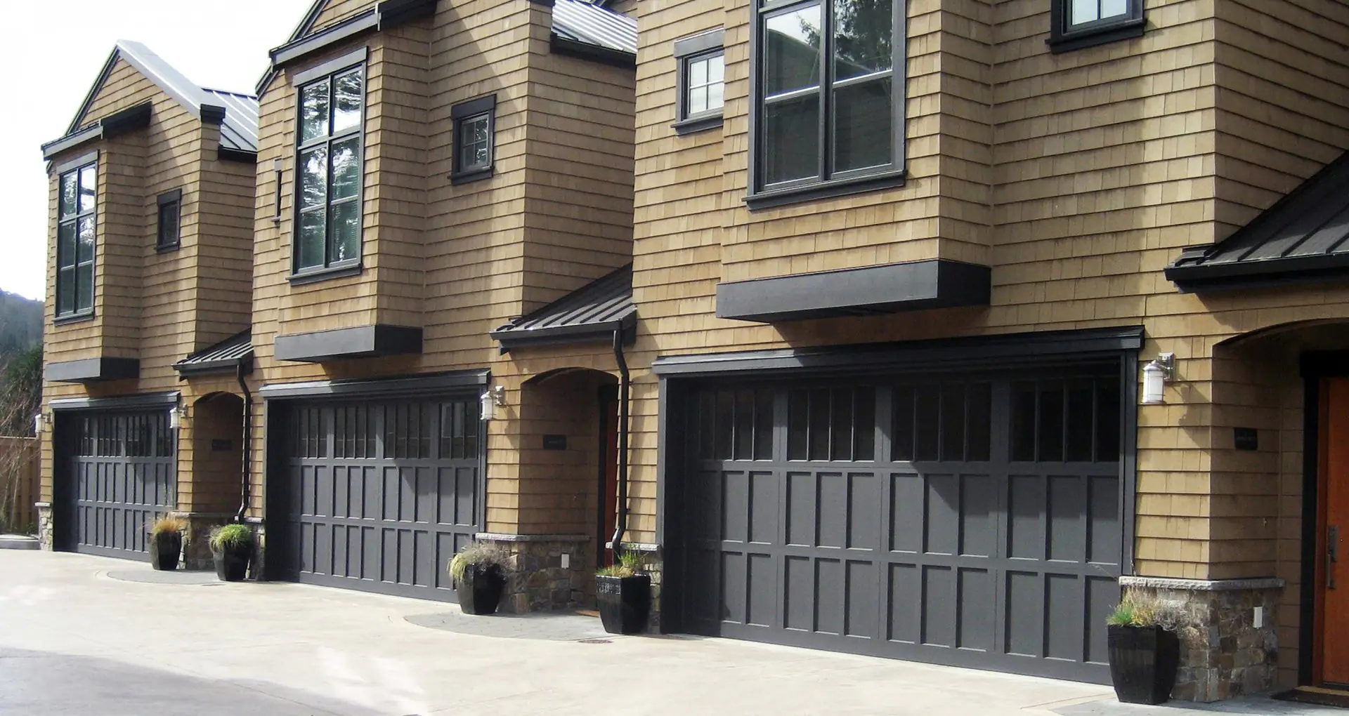 Townhomes with dark carriage-style garage doors