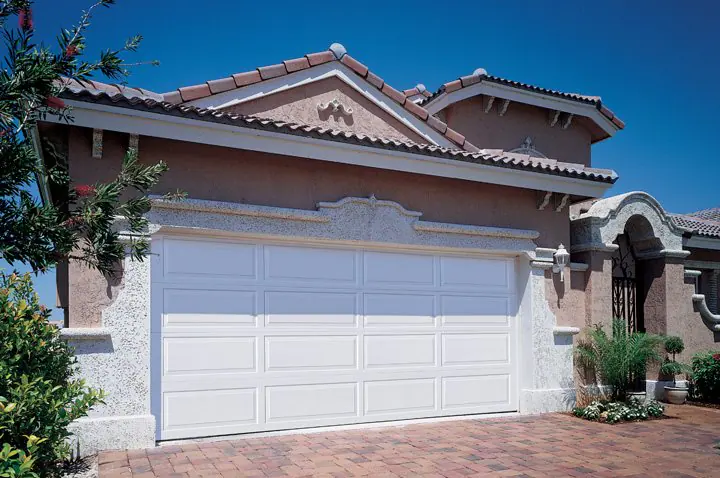 Single-story home with a white two-car garage door
