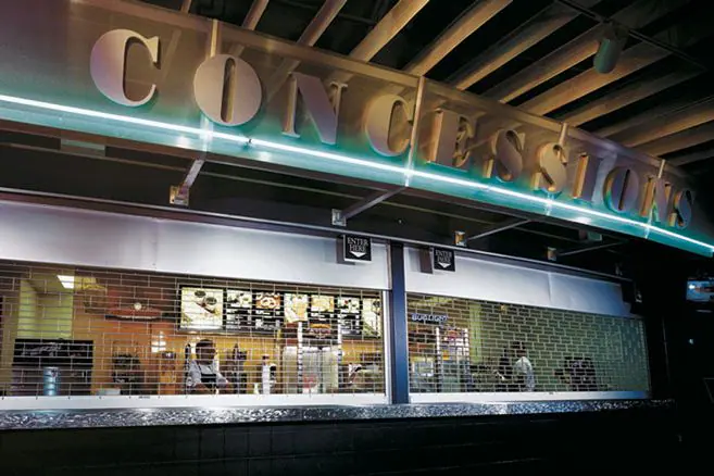 Rolling security grilles closed across a concession counter