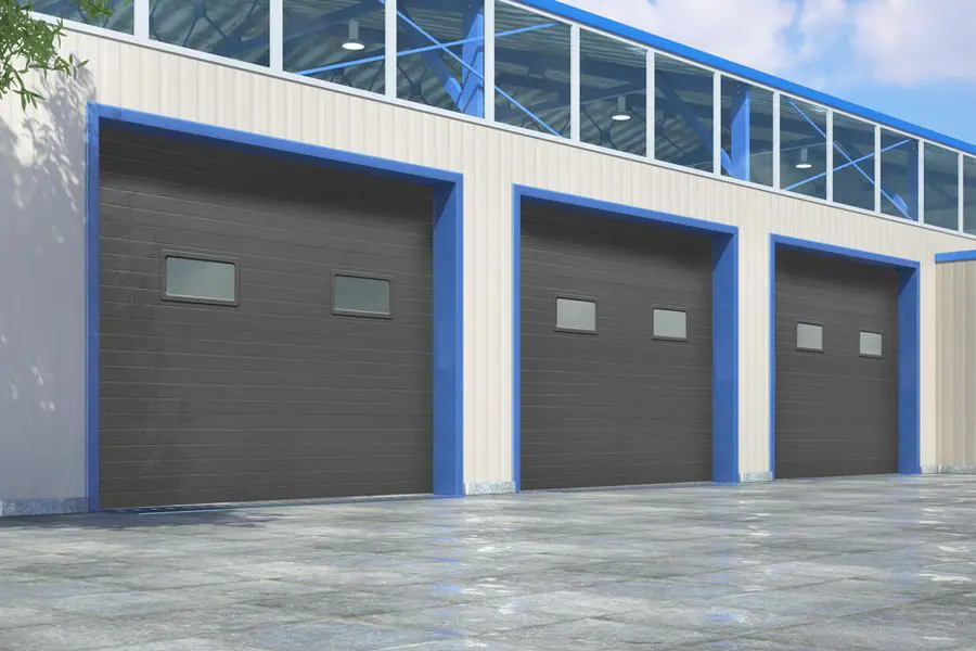 Three insulated sectional doors on a commercial building