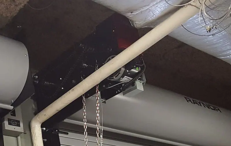 Chain hoist operator on a rolling steel door