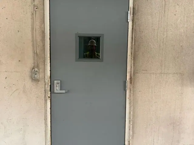 Steel pedestrian door at the side of a commercial building